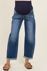 woman wearing a pair of blue maternity jeans with a rolled cuff and a stretchy navy waistband