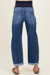 maternity wear: woman wearing blue cuffed maternity jeans with a stretchy waistband seen from the back