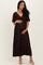 woman wearing a brown floral maternity maxi dress and holding her baby bump