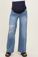woman wearing distressed wide-leg maternity jeans with a high waistband and ripped detailing