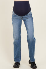 woman wearing a pair of light blue maternity jeans with a dark blue over-the-bump waistband and a slight distressed detail