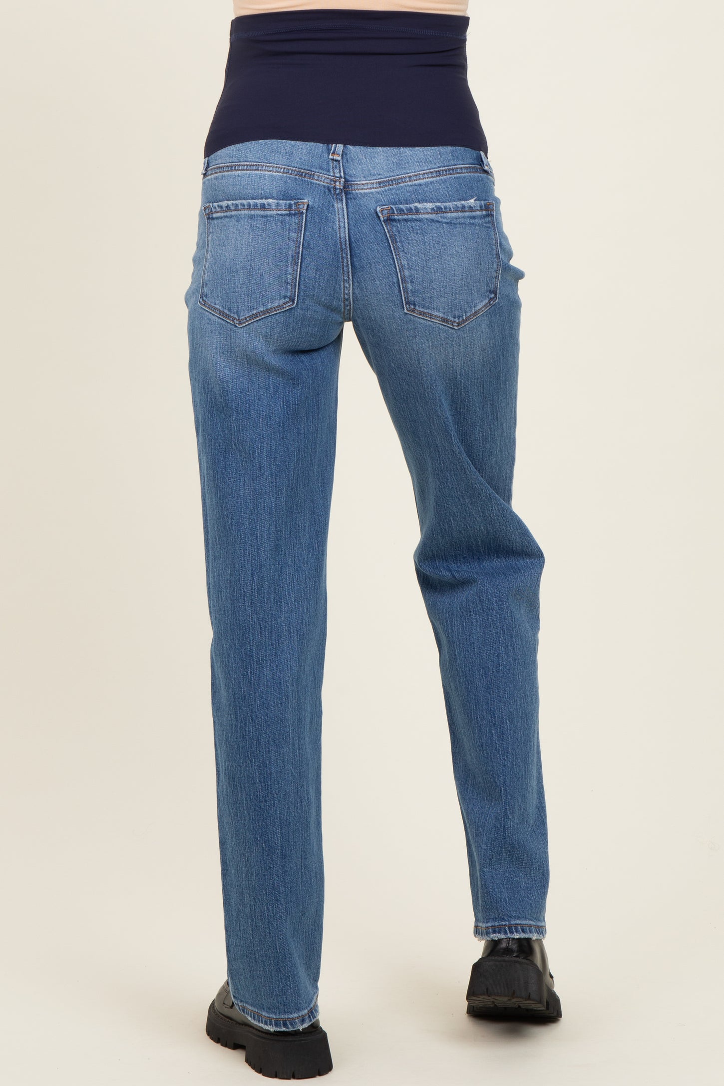 maternity wear blue straight-leg jeans with a navy over-the-bump panel, shown from the back