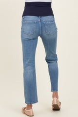 woman wearing light blue maternity jeans with a dark waistband, showing the back view