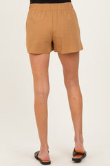 woman wearing tan maternity shorts with an elastic waistband and a relaxed fit, seen from the back