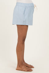 woman wearing light blue maternity shorts with an elastic waistband and drawstring detail