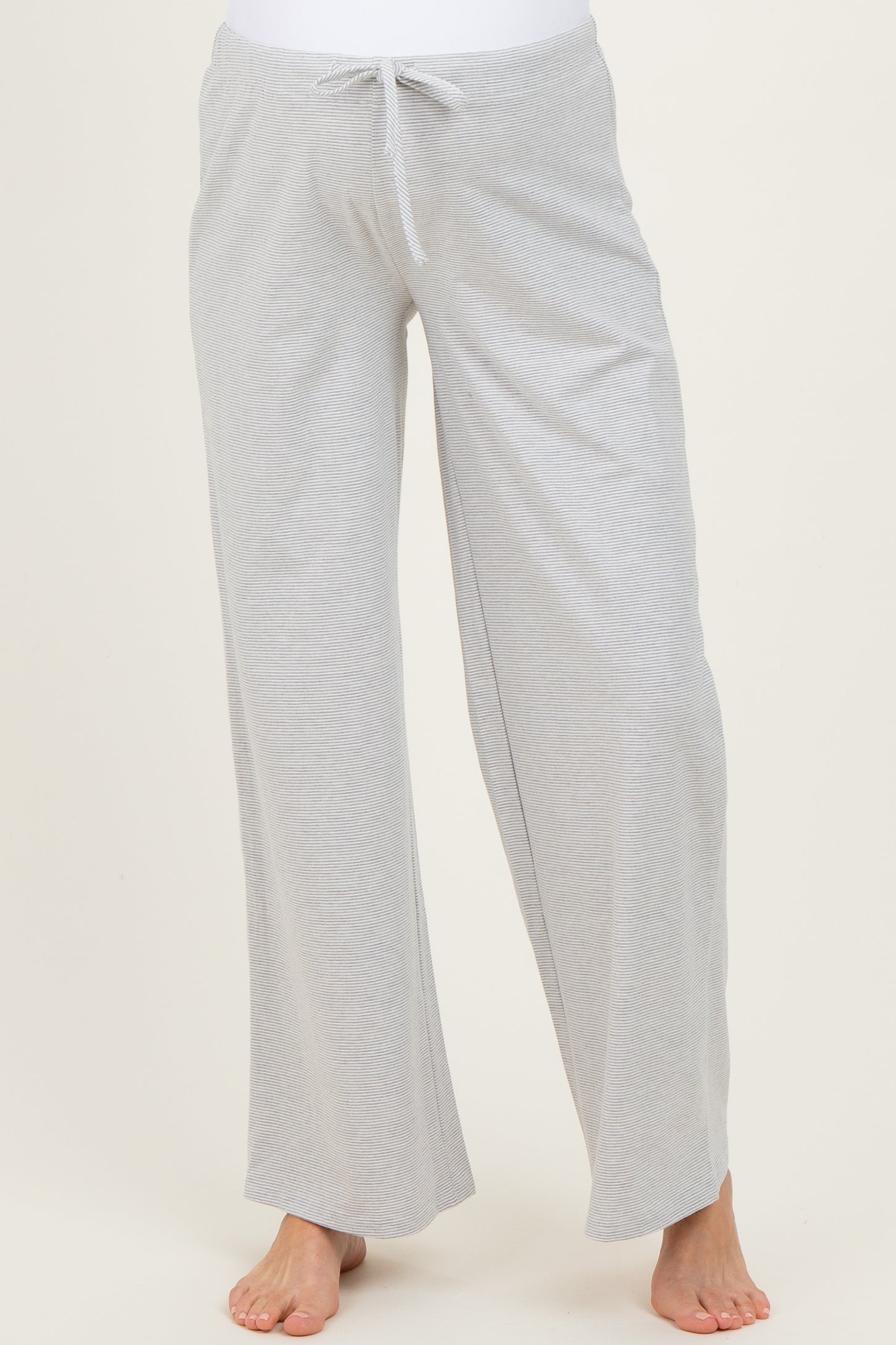 woman wearing soft grey maternity lounge pants with a drawstring waist and wide-leg fit