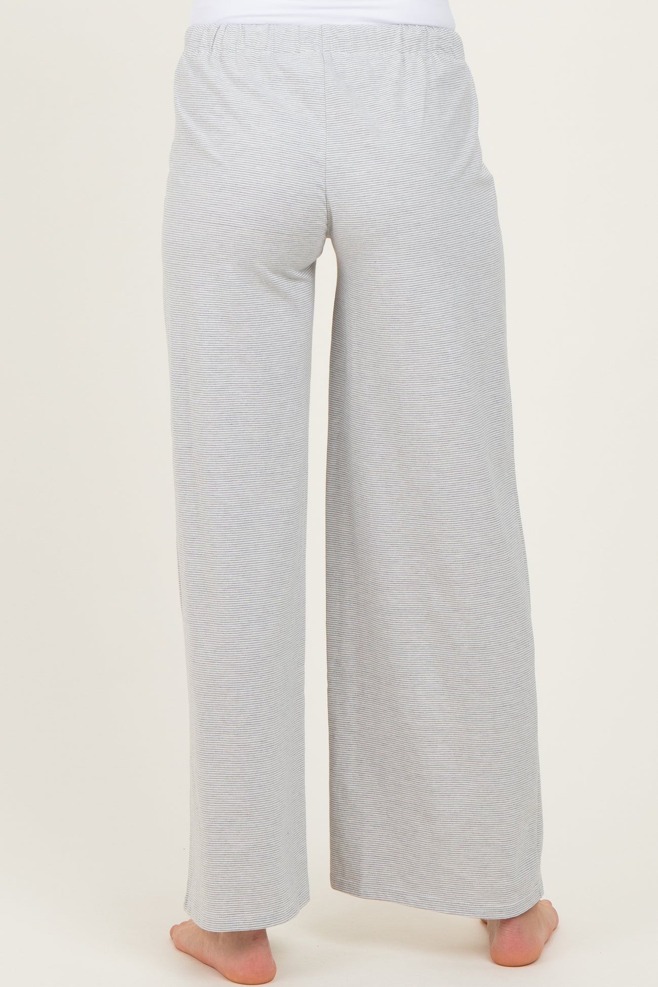 woman wearing light gray maternity lounge pants, shown from the back