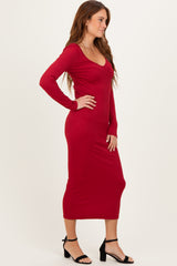 woman wearing a ribbed red long sleeve midi dress and black strappy heels