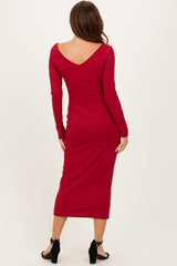 woman wearing a red ribbed midi dress with long sleeves and a v-back