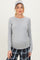 woman wearing a gray long sleeve maternity top with a slight stretch and pajama pants, showing her baby bump