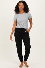 woman wearing a gray short sleeve t-shirt and black jogger pants with a drawstring waist