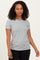 woman wearing a gray short sleeve t-shirt and black pants, standing in a neutral pose