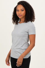 woman wearing a gray short sleeve t-shirt with a fitted style and standing sideways, showcasing a relaxed fit
