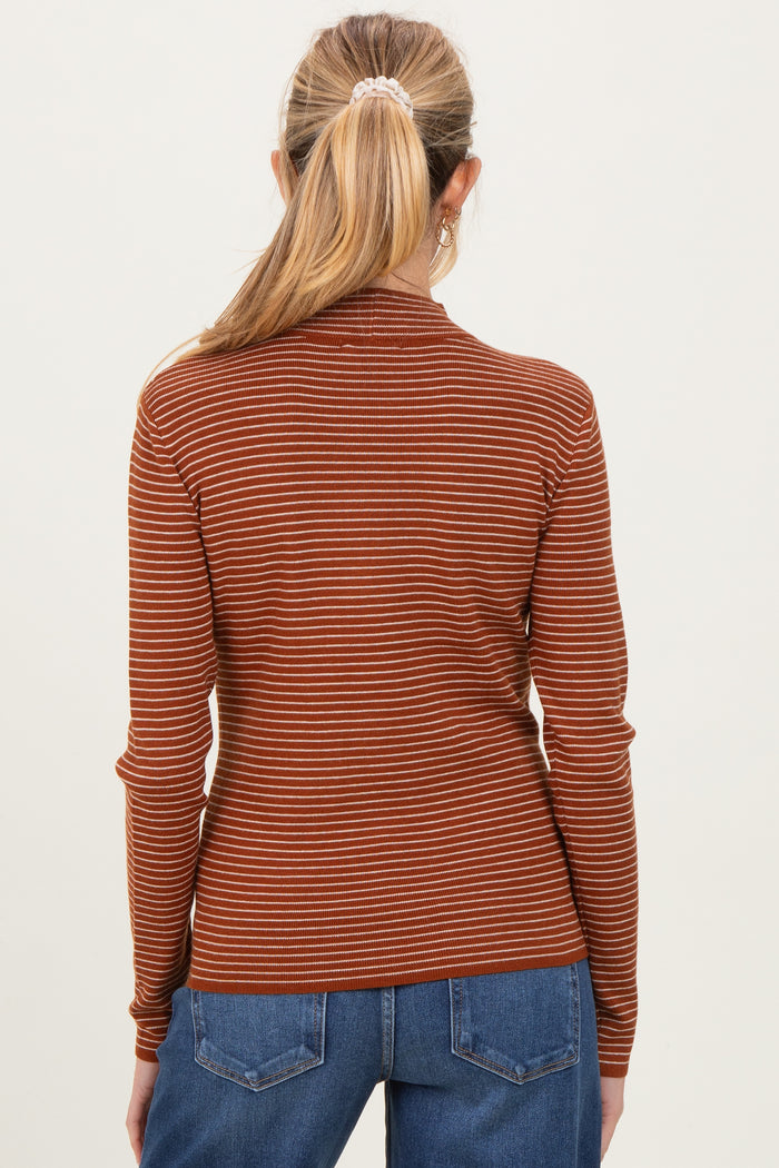 woman wearing a rust and cream striped maternity top with long sleeves, view from the back