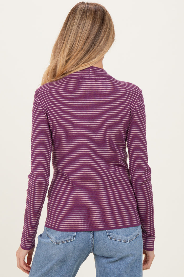 woman wearing a purple and pink striped long sleeve maternity top, showing the back view