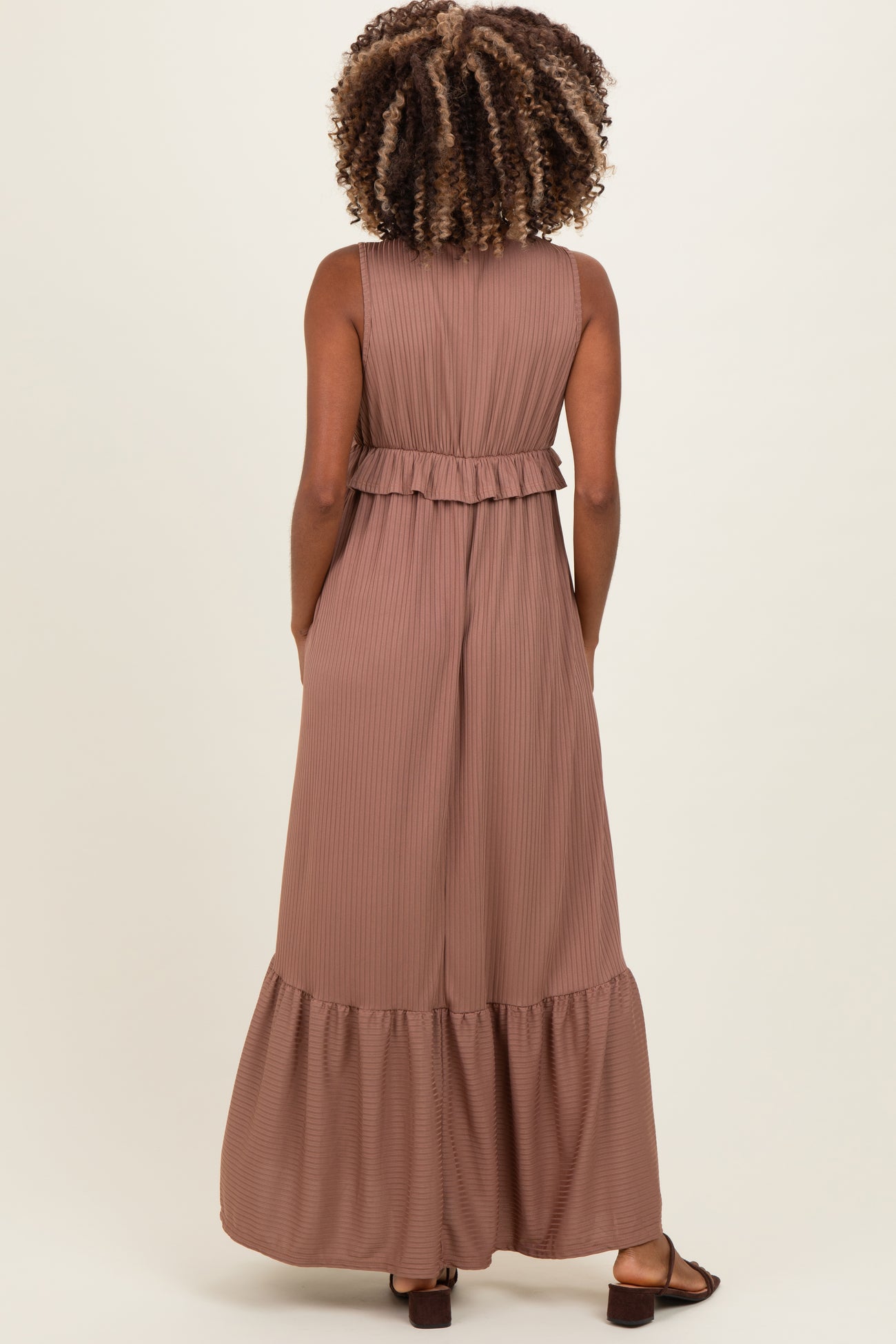 woman wearing a dusty rose maternity maxi dress with a ruffled waist and side pockets