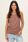 woman wearing a brown ribbed tank top with a fitted silhouette and ruched detailing, paired with light blue jeans