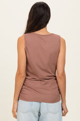 woman wearing a mauve sleeveless ribbed top, shown from the back with casual light blue jeans
