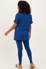 woman wearing a royal blue oversized t-shirt and matching leggings with back turned to the camera