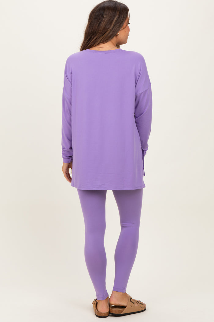 woman wearing a purple long sleeve maternity top and matching leggings, showing her back with relaxed fit