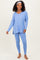 woman wearing a light blue long sleeve top with a v-neck and matching leggings