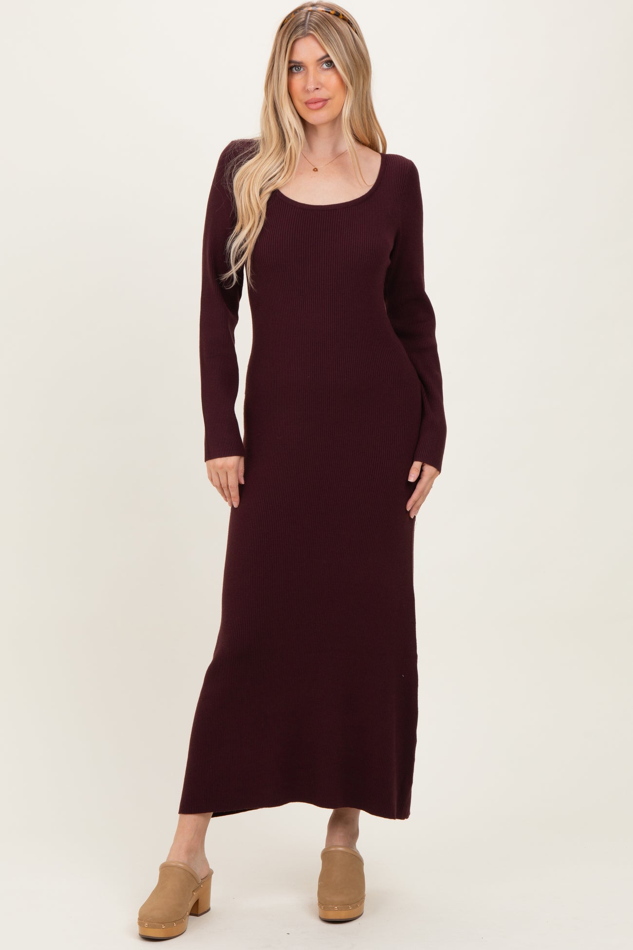 woman wearing a burgundy ribbed long sleeve maxi dress and tan clogs