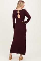 woman wearing a burgundy ribbed long sleeve maxi dress with a back cutout detail