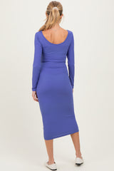 woman wearing a purple long sleeve maternity dress with a fitted ribbed design, showing a baby bump from the back
