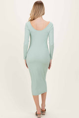 woman wearing a mint green ribbed midi dress with long sleeves, shown from the back