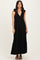 woman wearing a black striped maxi dress with tie shoulder straps and a tiered skirt