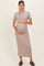 woman wearing a taupe ribbed maternity maxi dress and gently cradling her baby bump
