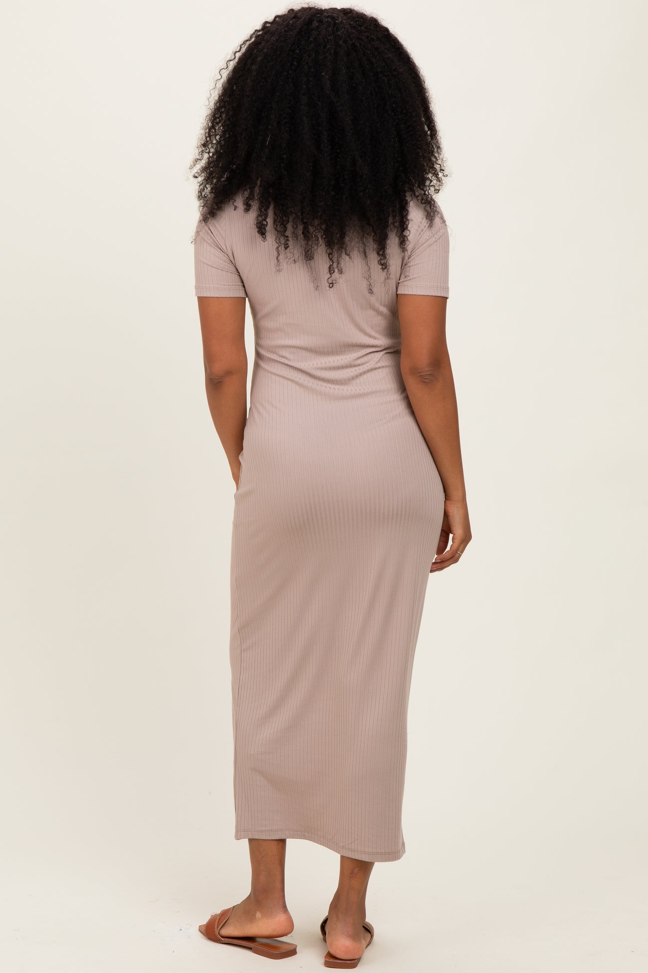 woman wearing a taupe ribbed maxi dress with short sleeves, viewed from the back