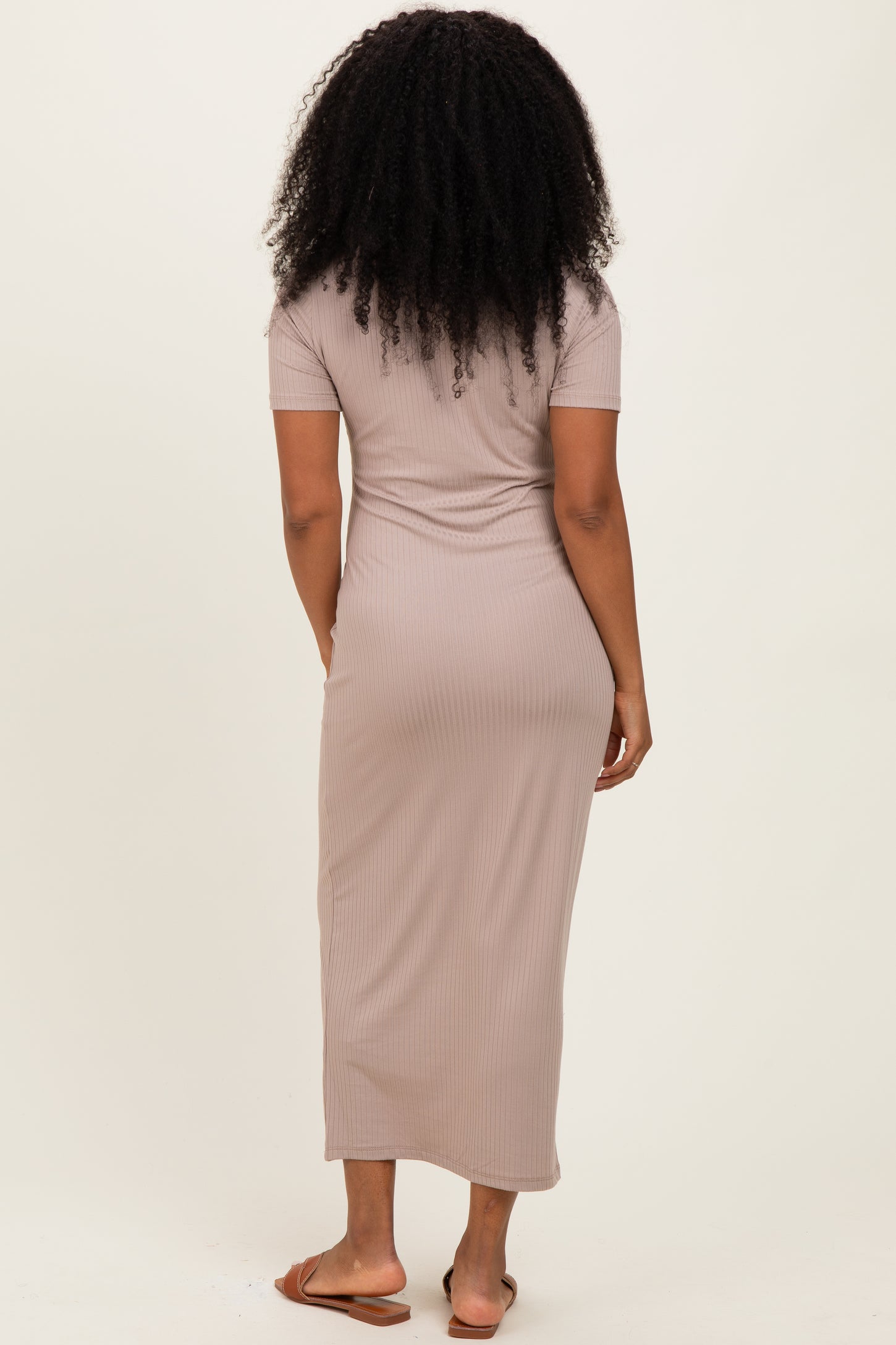 woman wearing a taupe ribbed maxi dress with short sleeves, viewed from the back