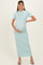 woman wearing a light mint green short sleeve maternity maxi dress and holding her baby bump