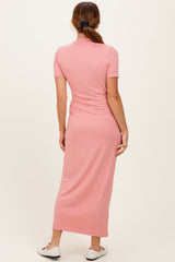 woman wearing a light pink ribbed maxi dress with short sleeves, view from the back