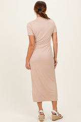 woman wearing a beige ribbed midi dress with short sleeves and a fitted silhouette, seen from the back