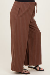 woman wearing brown striped maternity wide-leg pants with a drawstring waist and side slits