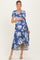 woman wearing a navy blue floral print maternity dress with short sleeves and a tie front, holding her baby bump