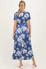 woman wearing a blue floral print maternity maxi dress with a relaxed fit and short sleeves, showing a baby bump