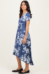 woman wearing a navy blue floral print midi dress with a belted waist and short sleeves