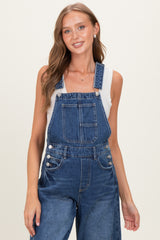 woman wearing a blue denim maternity overall with wide legs and adjustable straps