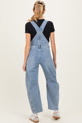 woman wearing light blue maternity overalls with a relaxed fit, showing the back view