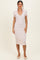 woman wearing a light pink short sleeve midi dress with a v-neck and collar
