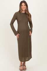 woman wearing a dark olive long sleeve maternity dress with a fitted silhouette and a visible baby bump