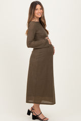 woman wearing a long sleeve olive green maternity dress and holding her baby bump