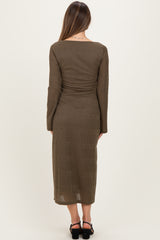 woman wearing a long olive green maternity dress with long sleeves and a fitted silhouette, showing a smooth back view