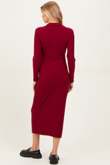 woman wearing a burgundy long sleeve maternity dress, shown from the back