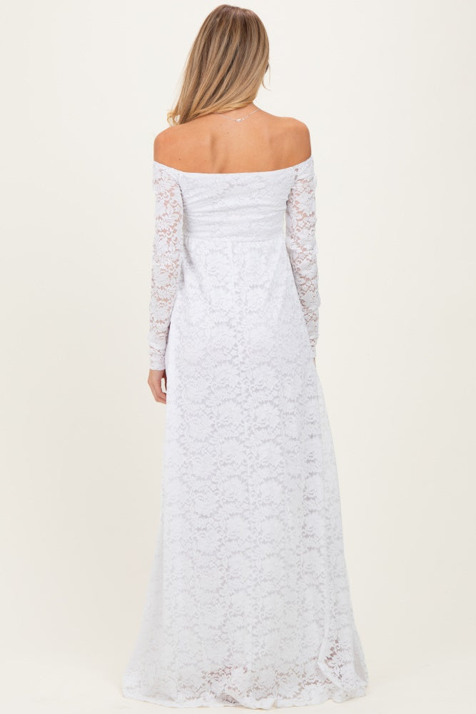 woman wearing a white off-the-shoulder lace maternity dress with long sleeves, showing a flowing skirt from the back