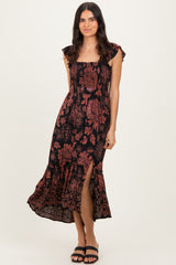 woman wearing a black floral maxi dress with ruffled sleeves and a side slit