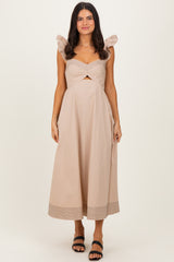woman wearing a light beige midi dress with pleated sleeves and a twisted front detailing